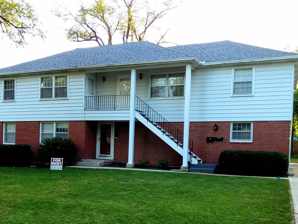 Front view from Travis Lane, with large yard and driveway entrance to back.