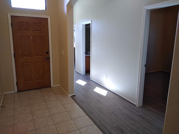 Entrance and hallway to three bedrooms and full bath.