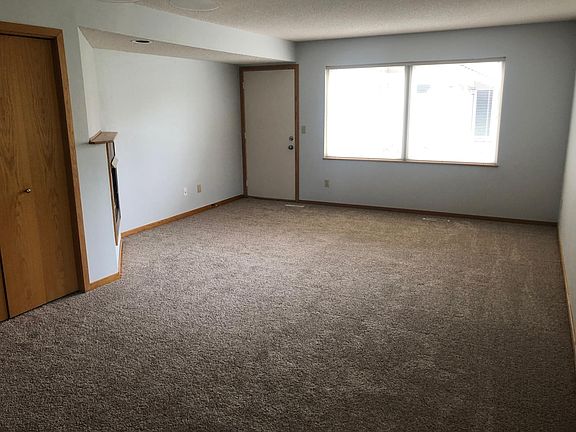 Large windows in living room. Door leads to private patio