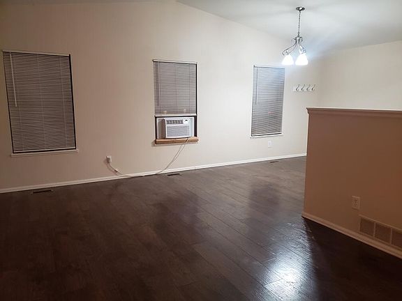 Upstairs living room and dining room with 3 windows and AC unit