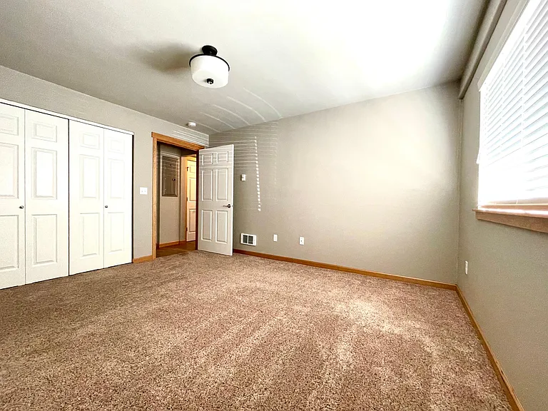 Roomy bedroom, with a bit of a walk-in closet.