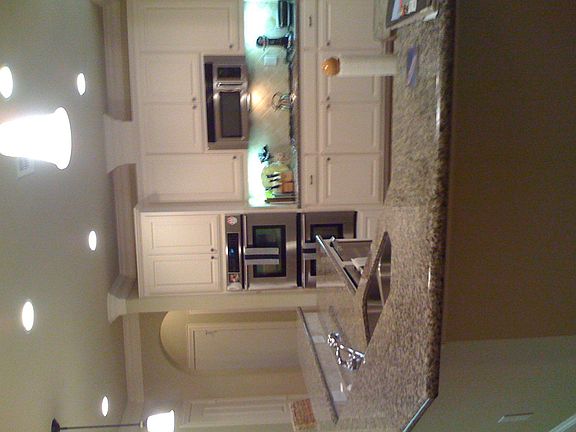 Kitchen with Dual Stainless Ovens and Granite Countertops