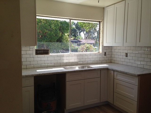 new cabinets, marble counters and subway tile backsplash