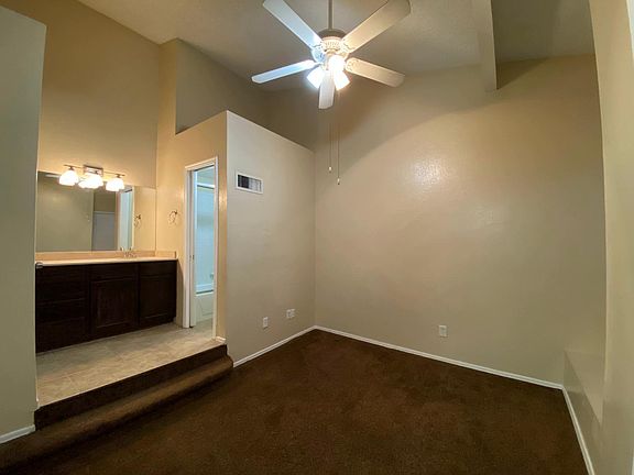 Primary BR with vaulted ceilings and window seat