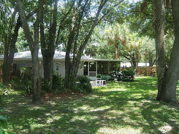 Western View of Oak and Palm Shaded Back Area and the West Side Screened Porch