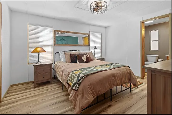 Primary bedroom boasts an adjustable, therapeutic queen-sized bed with armoire with ensuite bath.