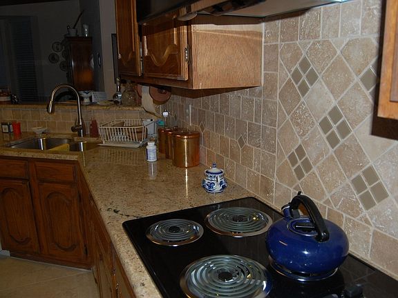 New floor tile, counter tops, electric range & hood, and sink.