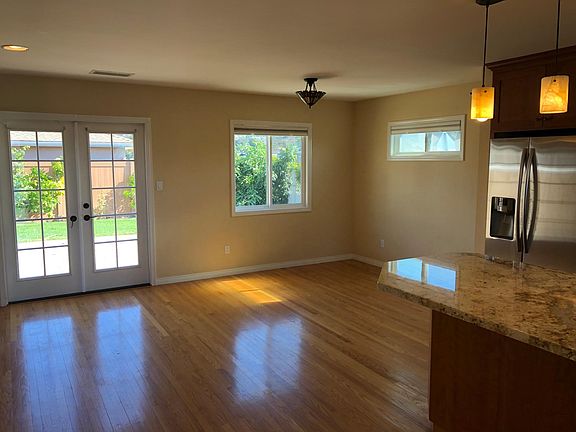 Plenty of light and hardwood floors lead to outside patio