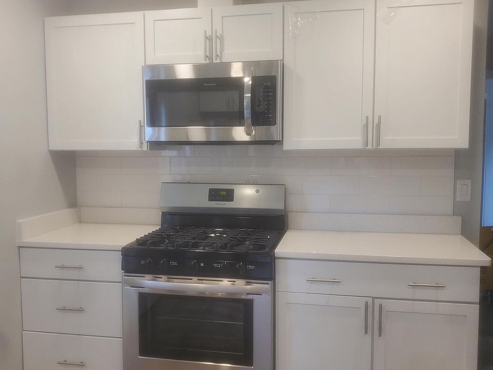 New stove, microwave, cabinets and flooring with new paints