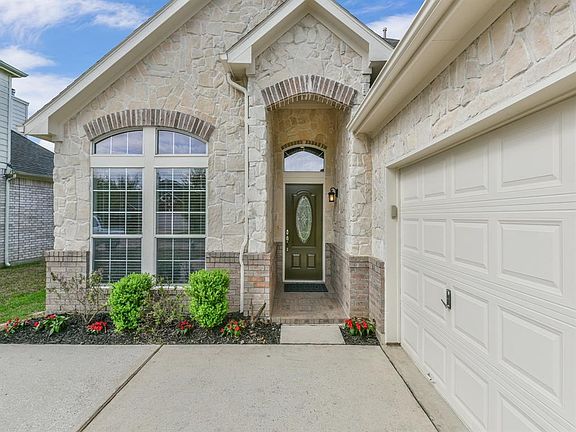 Stone front gives this home a unique look in the neighborhood and glass panel door invites you in.