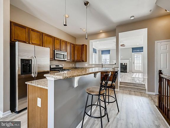 Light filled eat in kitchen flows to a living room and deck. There is also a half bath on this floor.