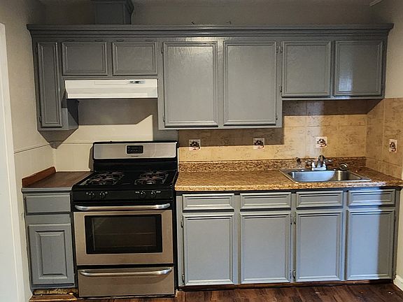 Kitchen with fresh paint and Stove.