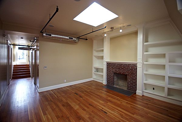 Living Room with Built-in Storage and Brick Fireplace