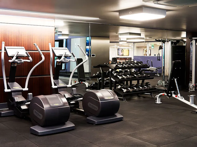 Expansive fitness center with elliptical, free weights, and weight stations