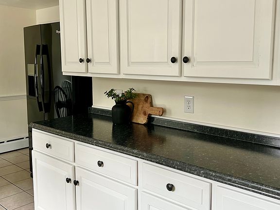 Kitchen; right side - entry to hallway with bedrooms / bathroom / living room around the refrigerator