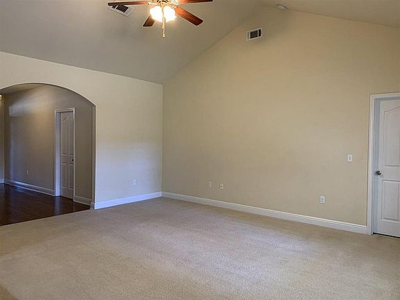 Carpet in living room has been replaced with tile flooring.