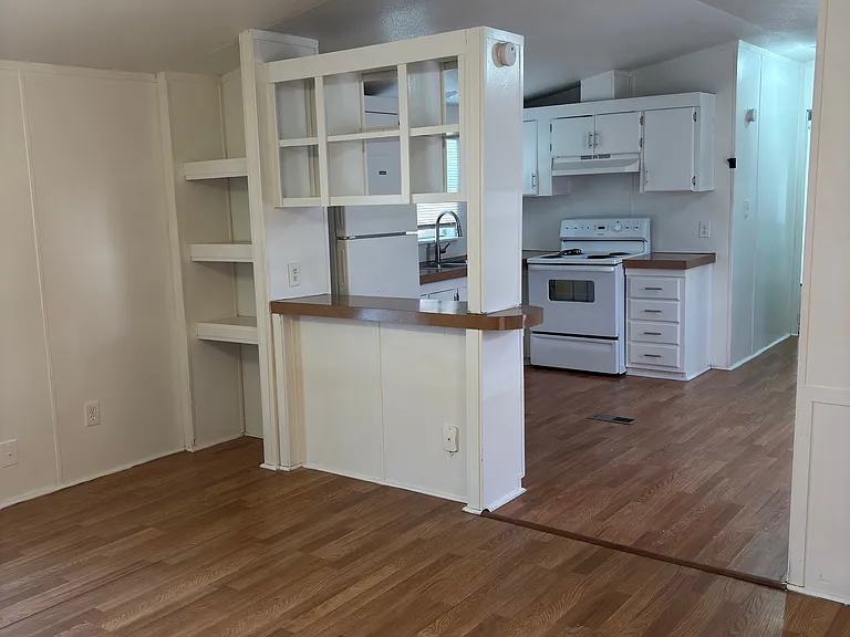 Living room opens into the kitchen