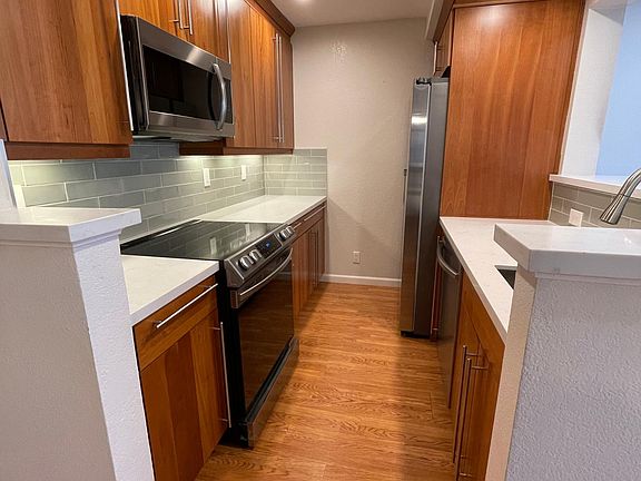Updated galley kitchen with brand-new Samsung appliances.