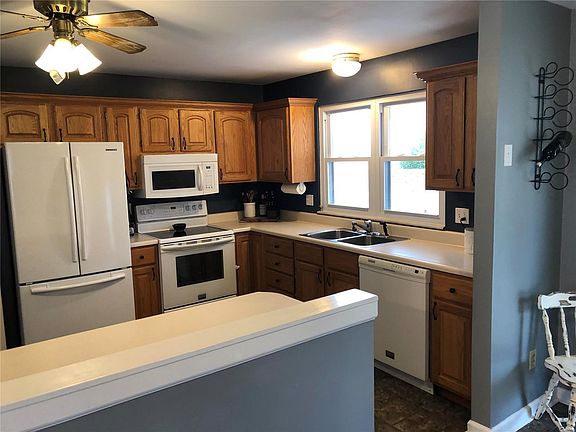 View of Kitchen from Dining Room.  Half Wall with Breakfast Bar and opens Kitchen to Dining Room
