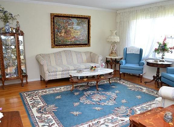 Large living room with exposed hardwood floors