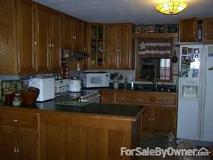 Kitchen has custom oak cabinets
						:
						Kitchen has new vinyl flooring. Dishwasher is in the island. New sink / faucet