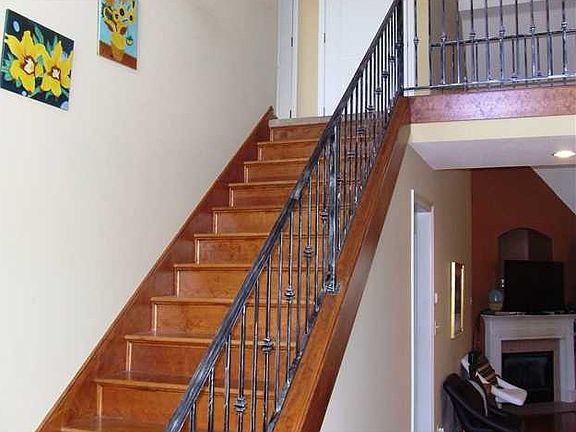 Oak tread stairway and wrought iron railing