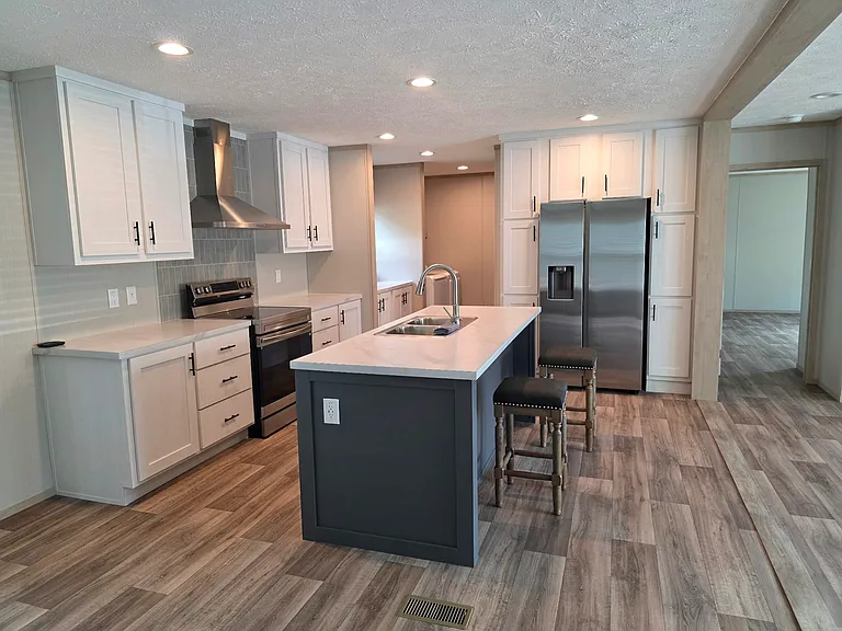 Loads of storage surrounding the refrigerator. Additional storage area across from the washer/dryer not pictured.