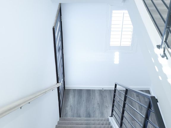 Front Entrance and Staircase to Second Floor Living Room and Kitchen