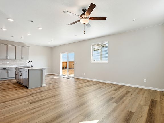 The family room is spacious with a ceiling fan.