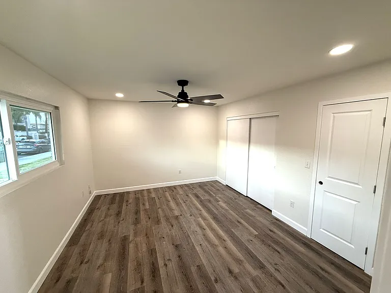 Primary bedroom on entry level with wardrobe closet and a separate walk-in closet and access to primary bath