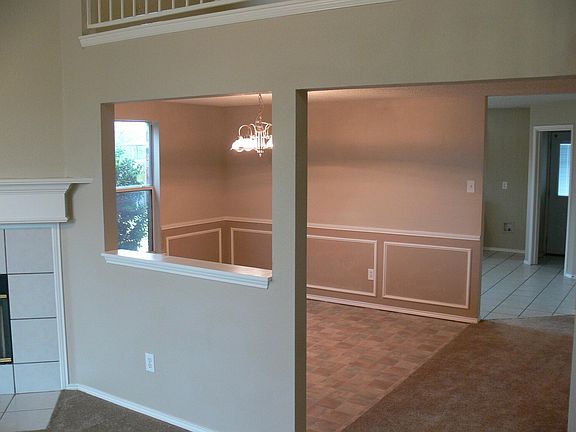 Dining room seen from living room, with kitchen beyond