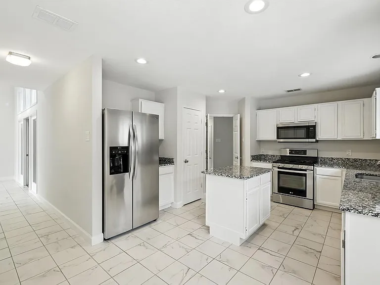Sunroom connected to kitchen by a walkthrough