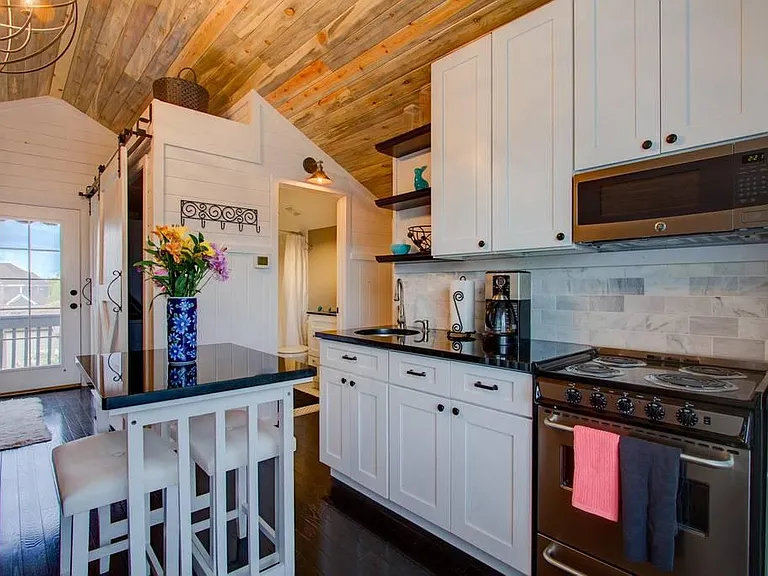 Magazine-worthy carriage house, fully furnished. At 550 sq ft this would be a giant TINY HOME