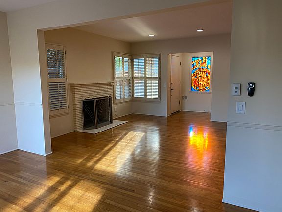 Wood burning fireplace and beautiful stain glass window.