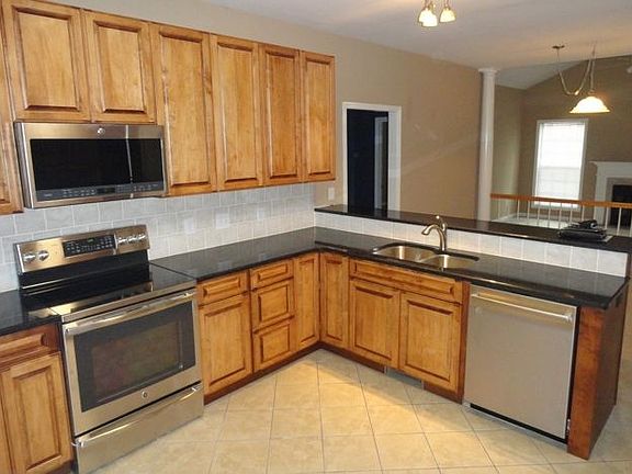 New granite countertops, custom cabinetry and stainless appl