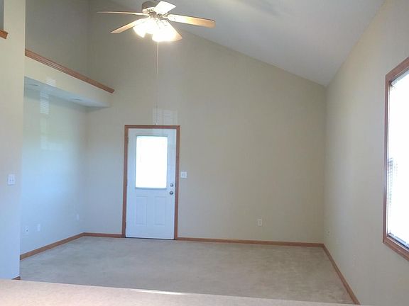 A light-filled great room w/ niche for bookshelves or TV.