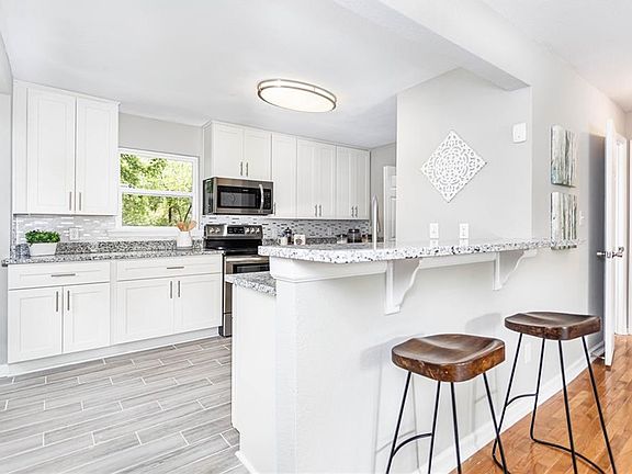 Pass-through features a granite-topped breakfast bar.