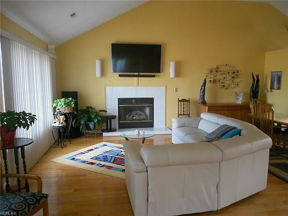 Great Room open from front of house to rear of house.  Tall cathedral ceiling. Ceiiling fan with light, propane gas fireplace, and lots of cabinetry and storage.