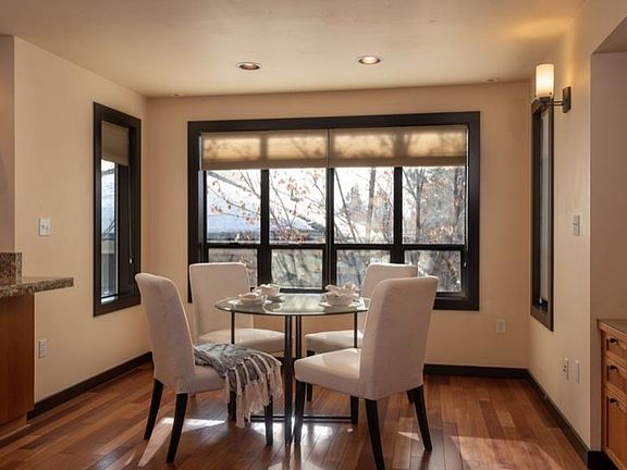 Dining nook can accommodate a table for 6. Deciduous trees provide shade and a beautiful green canopy outside the kitchen and dining room windows spring through fall.