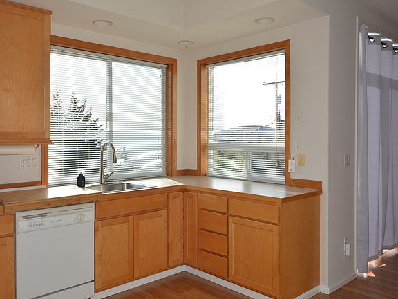 Natural Kitchen lighting with blonde cabinets and great views.