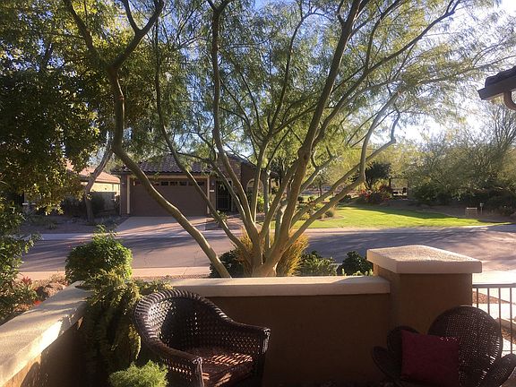 View from front enclosed patio overlooking a small pocket park and golf course