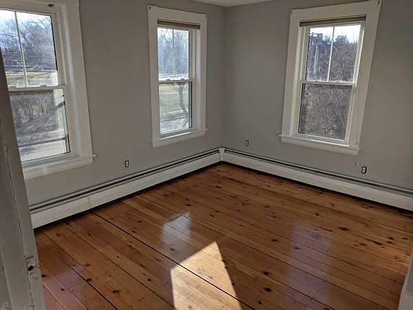 Bedroom with original hardwoods, lots of natural light. Good size closet.