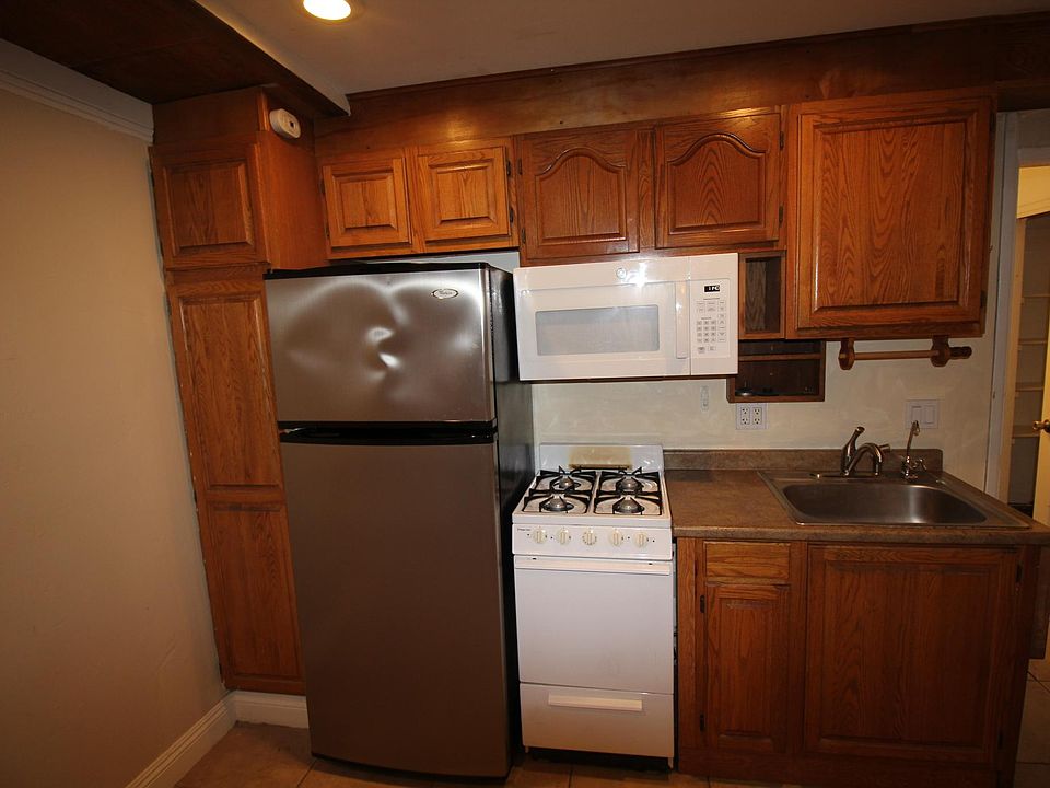 Close-up of kitchenette. Includes a microwave, stove/oven, sink, and refrigerator (unless you have your own).