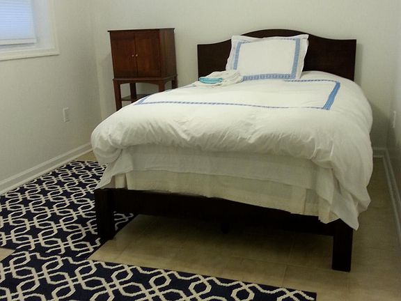 queen size bedroom with a night stand