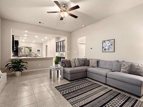 Large tile throughout the living areas create a consistent flow throughout the kitchen and living room.
