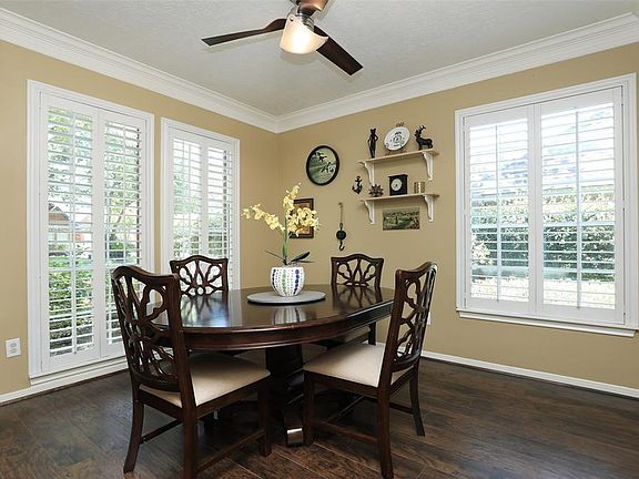 Sophisticated Formal Dining Room has Plantation Shutters, Double Crown Molding...