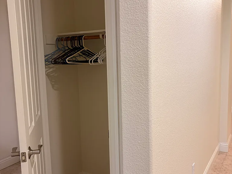 Hall coat closet near laundry room