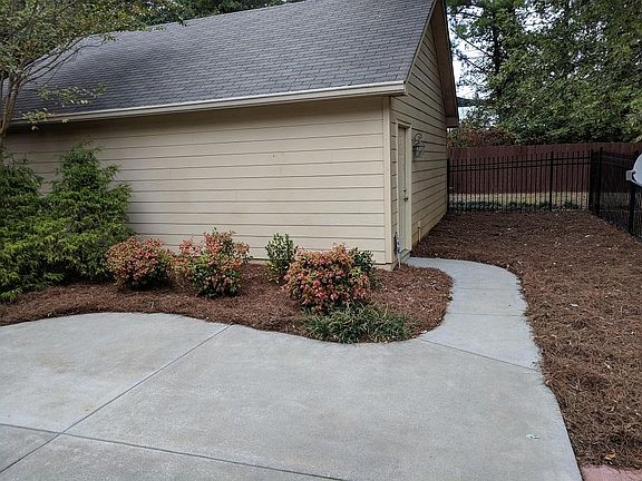 Patio and Garage with stairs to attic for storage