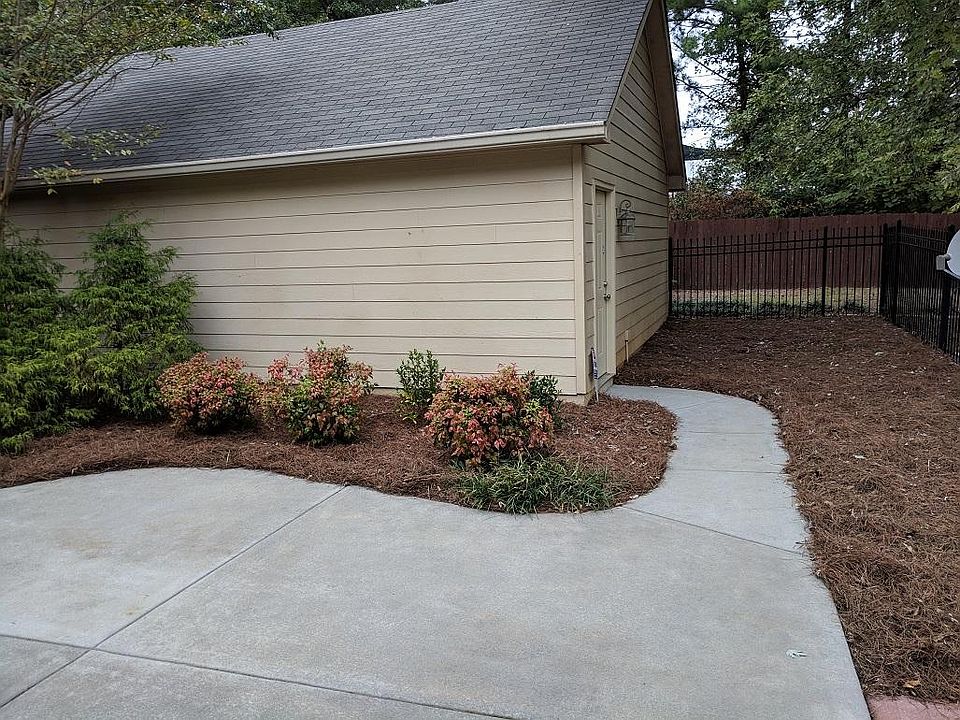 Patio and Garage with stairs to attic for storage