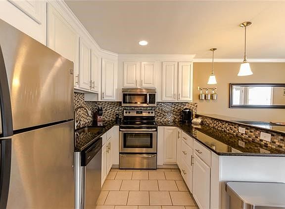 Kitchen view with granite counters, custom cabinets, perfect for cooking and entertaining!